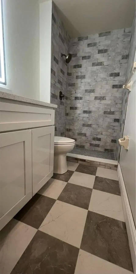 Full Bathroom Rebuild after the work — a finished bathroom with new tile, vanity and fixtures