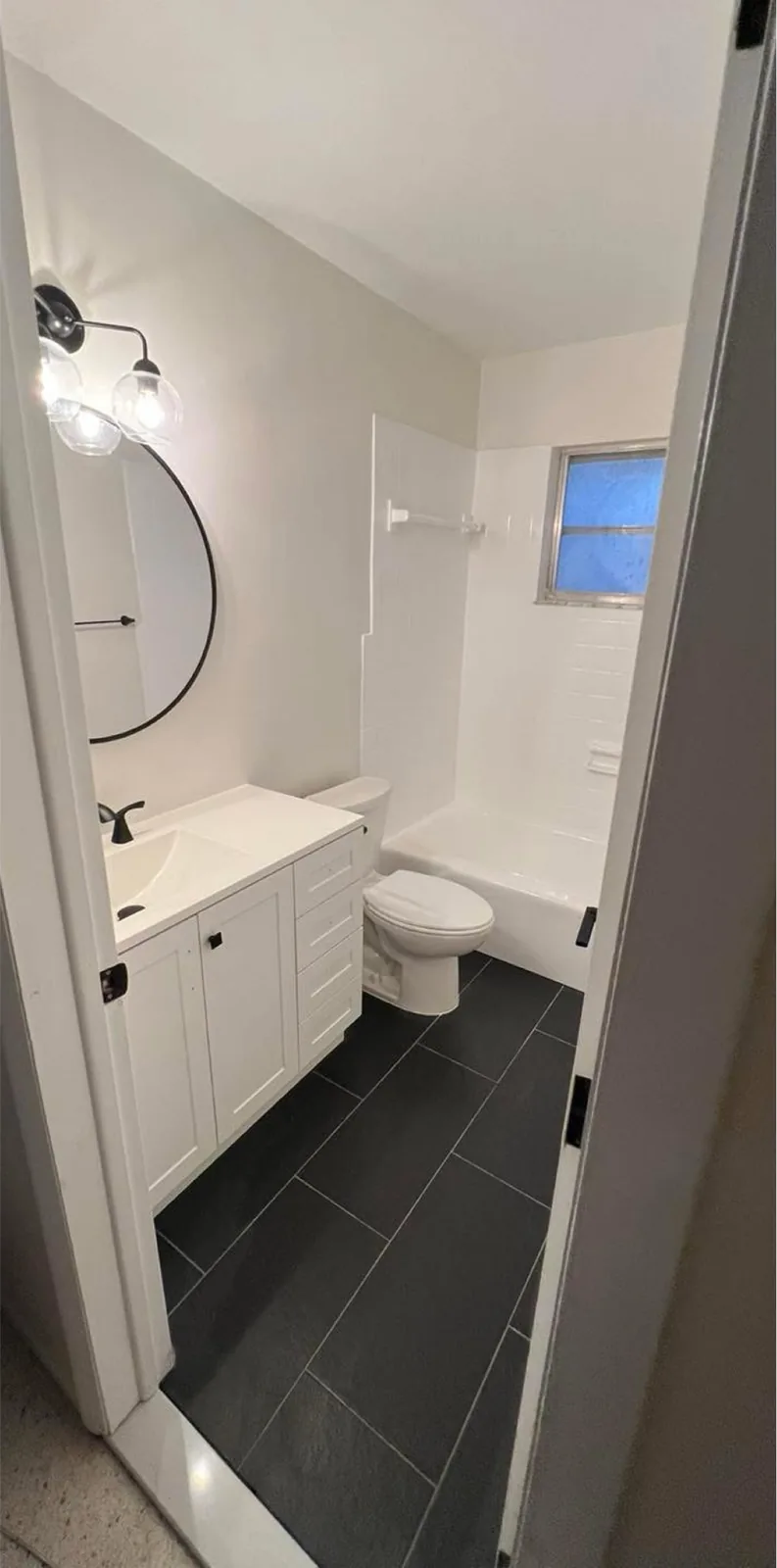 Bathroom Refresh after the work — new fixtures, fresh paint and updated hardware
