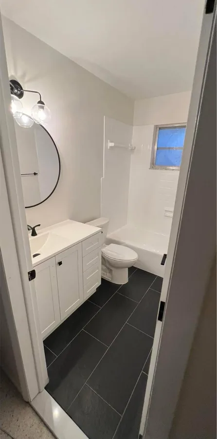 Bathroom Refresh after the work — new fixtures, fresh paint and updated hardware