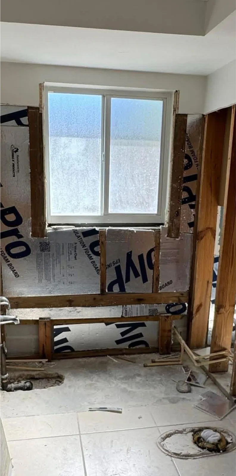 The same view before — a stained tub and cracked surround
