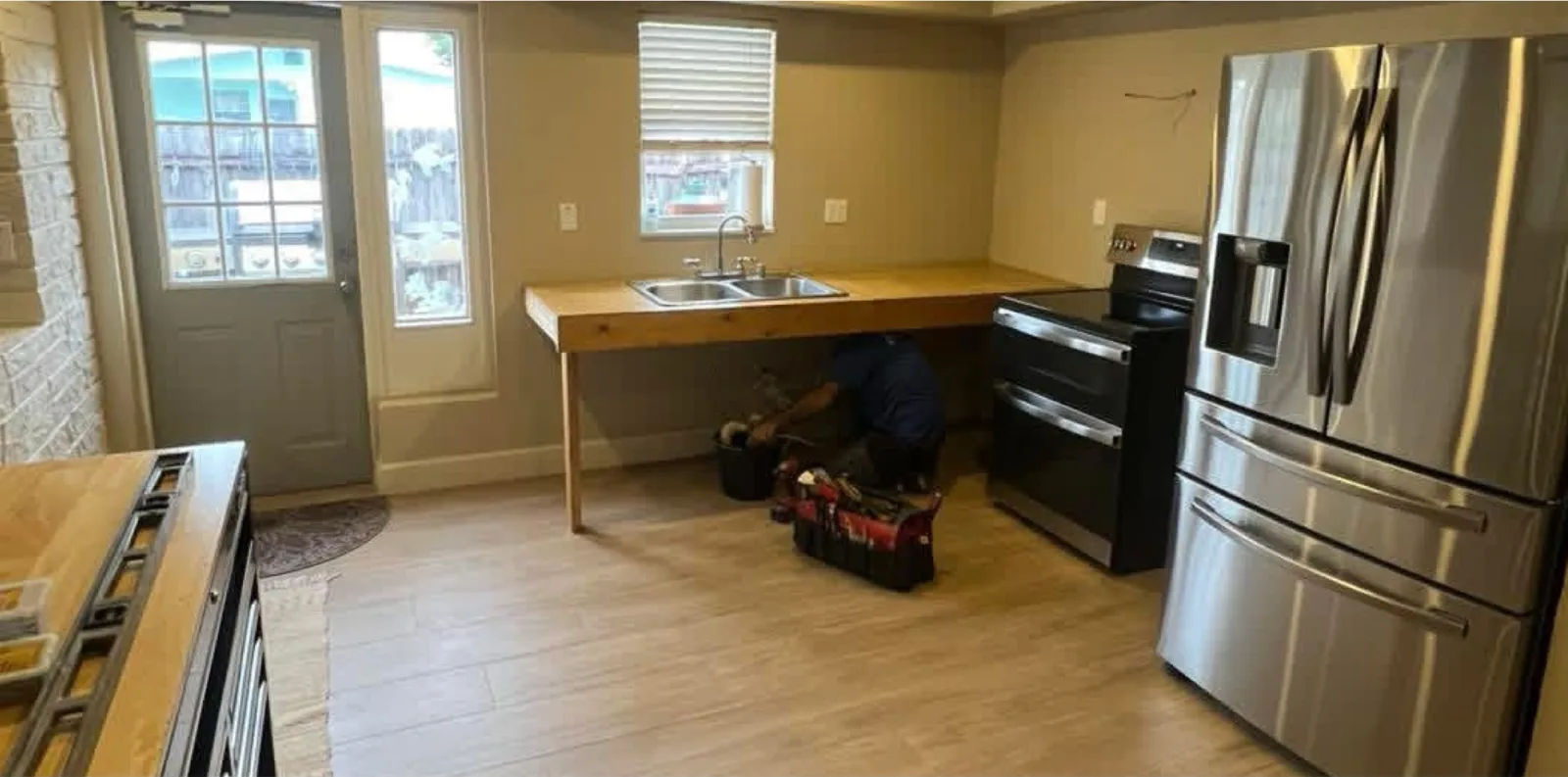 The same view before — a closed-in kitchen with dated cabinets and worn flooring
