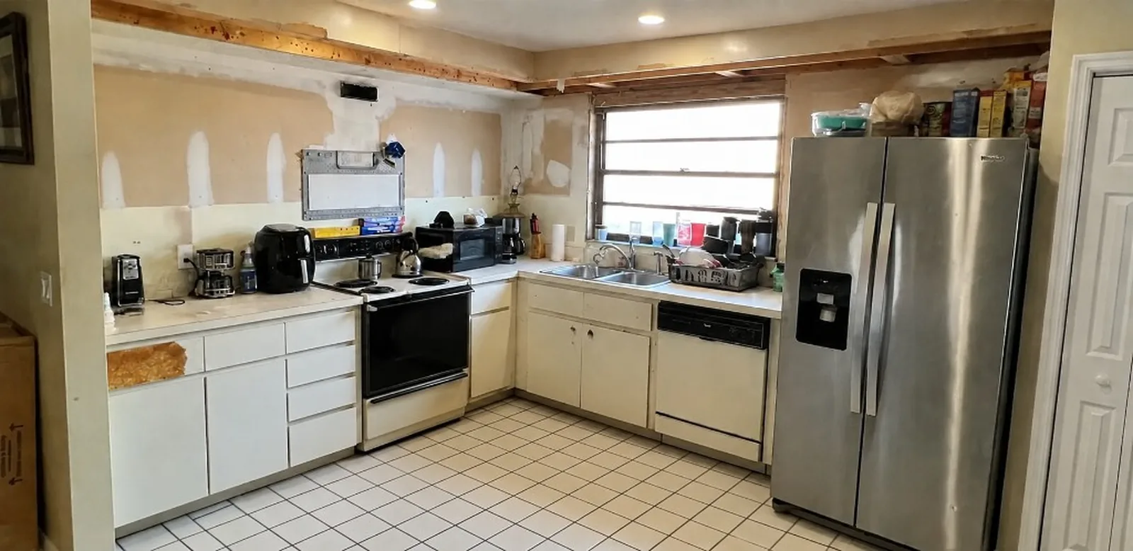The same view before — worn oak cabinets and mismatched hardware