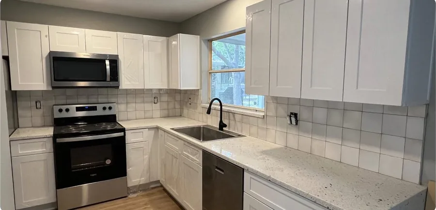 Shaker Cabinet Refit after the work — shaker cabinet doors with new pulls and finished trim