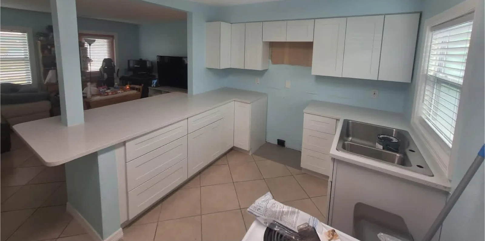 Bright White Kitchen after the work — bright white cabinetry and a light backsplash