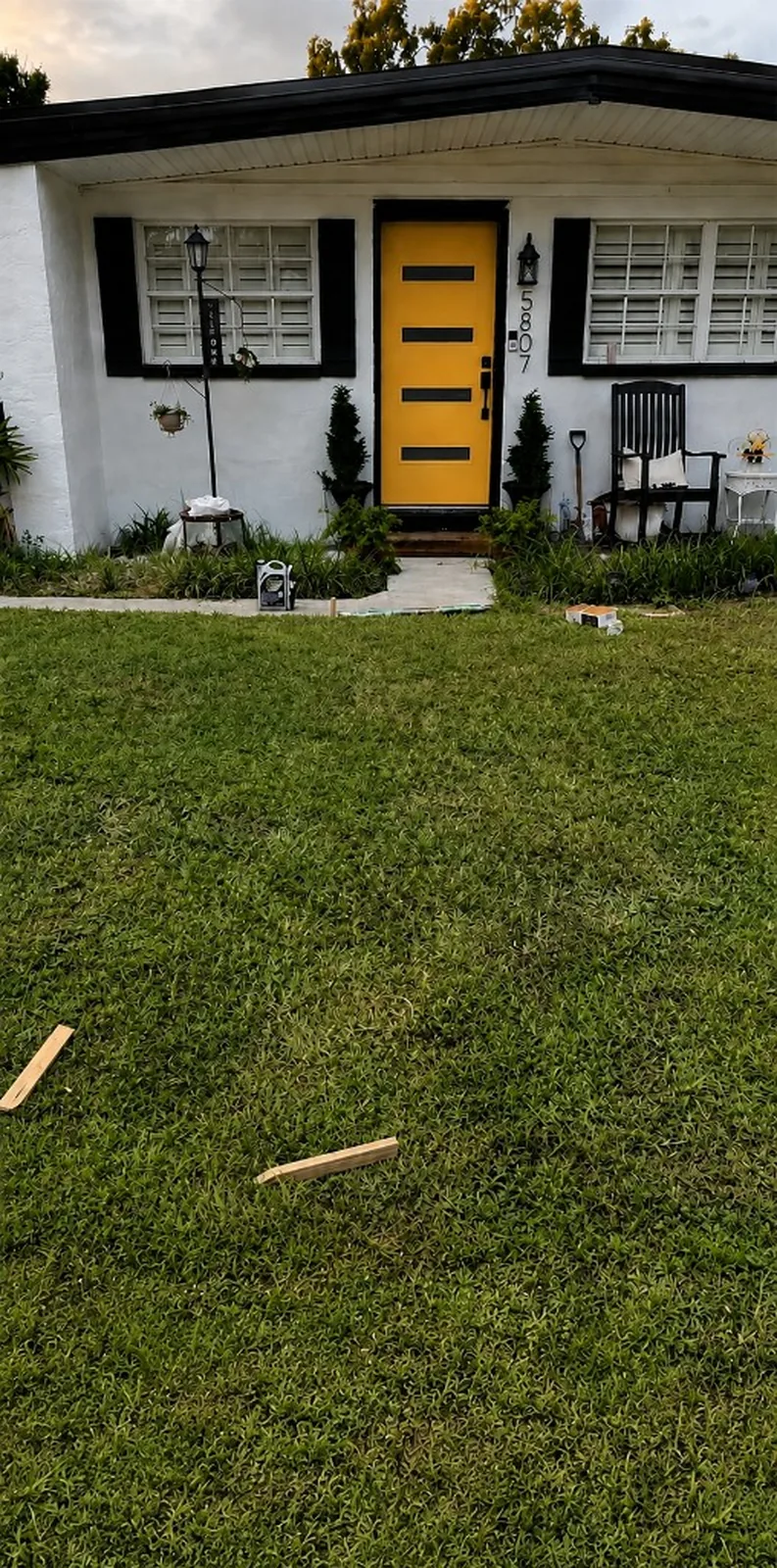 The same view before — bare grass with no path to the door