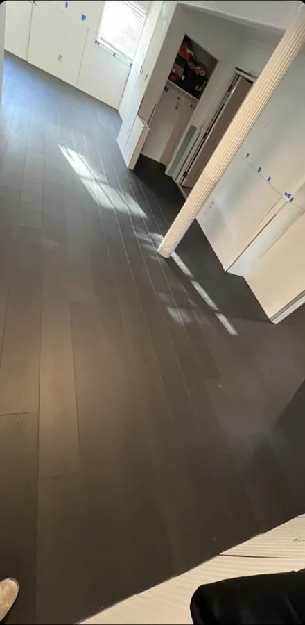 New wood-look plank flooring installed through a living room