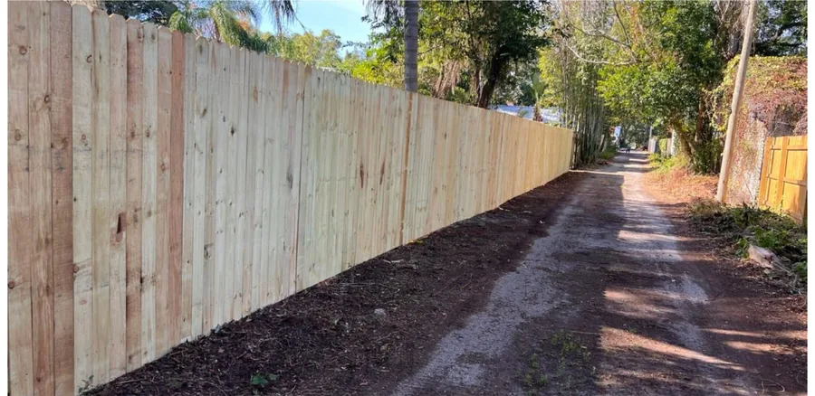 New wood privacy fence running along a back garden boundary